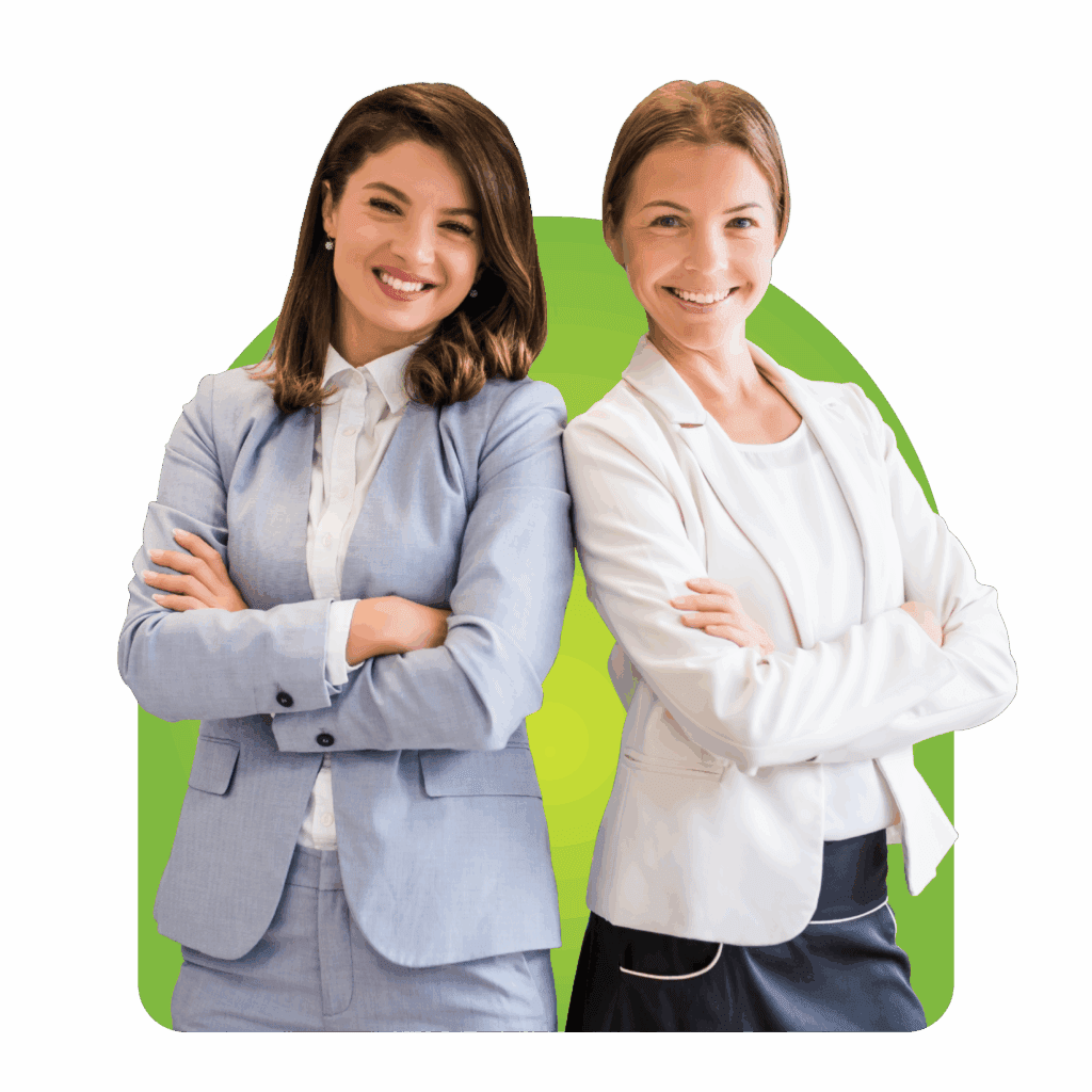 Two professional women in business suits smiling with arms crossed